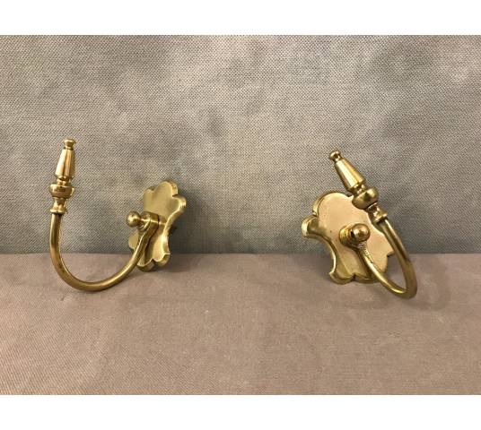 Pair of brass fireplace hooks from the 19th century