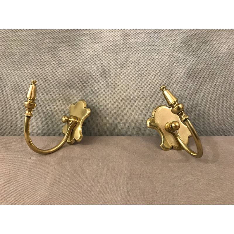 Pair of brass fireplace hooks from the 19th century