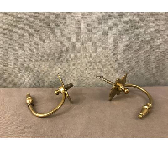 Pair of brass fireplace hooks from the 19th century