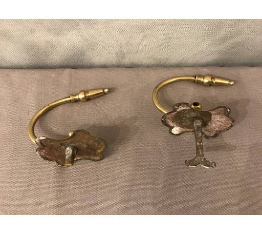 Pair of brass fireplace hooks from the 19th century