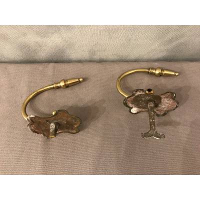 Pair of brass fireplace hooks from the 19th century