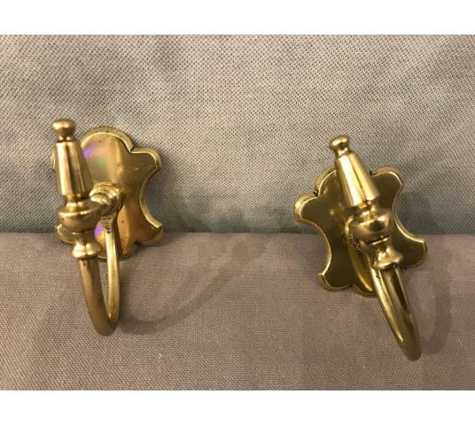 Pair of brass fireplace hooks from the 19th century