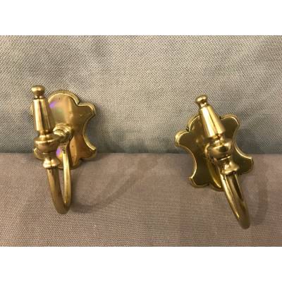 Pair of brass fireplace hooks from the 19th century