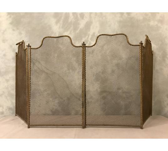 Old gilded iron fireplace firewall from the 19th century