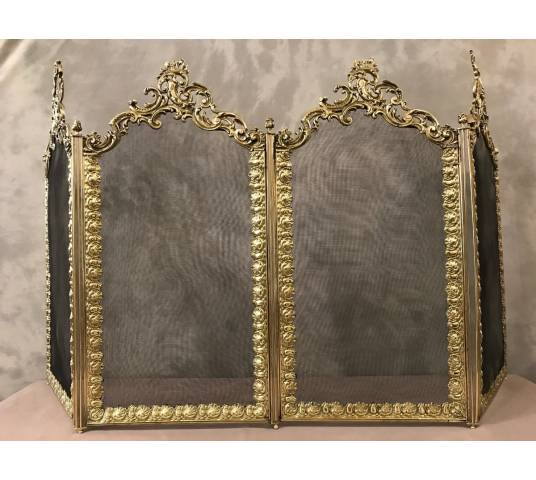 Beautiful old fireplace firewall in bronze and brass from the 19th century