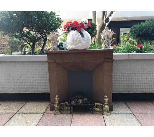 Small decorative fireplace in natural wood from the late nineteenth century