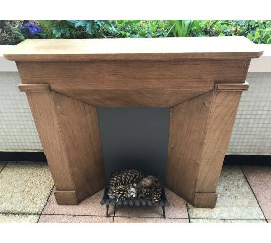 Small decorative fireplace in natural wood from the late nineteenth century