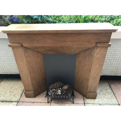 Small decorative fireplace in natural wood from the late nineteenth century