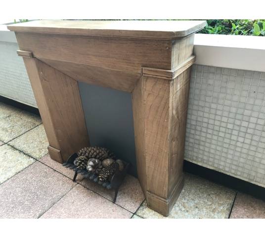 Small decorative fireplace in natural wood from the late nineteenth century