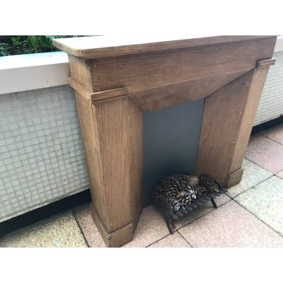 Small decorative fireplace in natural wood from the late nineteenth century