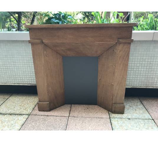 Small decorative fireplace in natural wood from the late nineteenth century