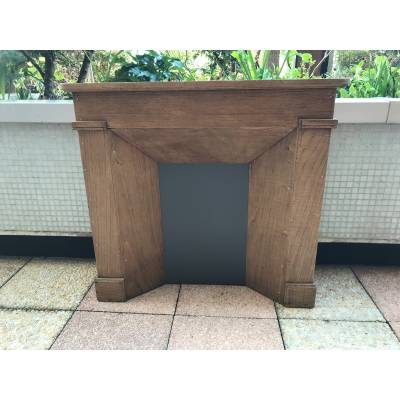 Small decorative fireplace in natural wood from the late nineteenth century