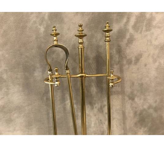 Antique fireplace set in polished brass and varnish from the 19th-century.